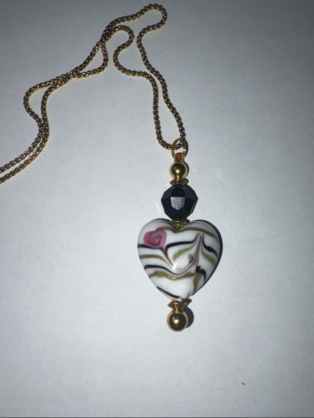 Hand Crafted Gold-Tone Necklace with White Swirl Heart and Black Bead